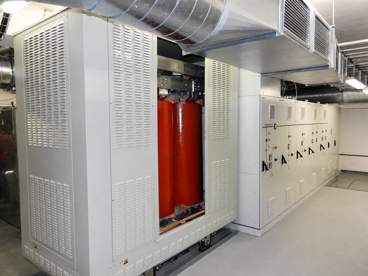 Ventilated dry-type transformer enclosure beside indoor switchgear